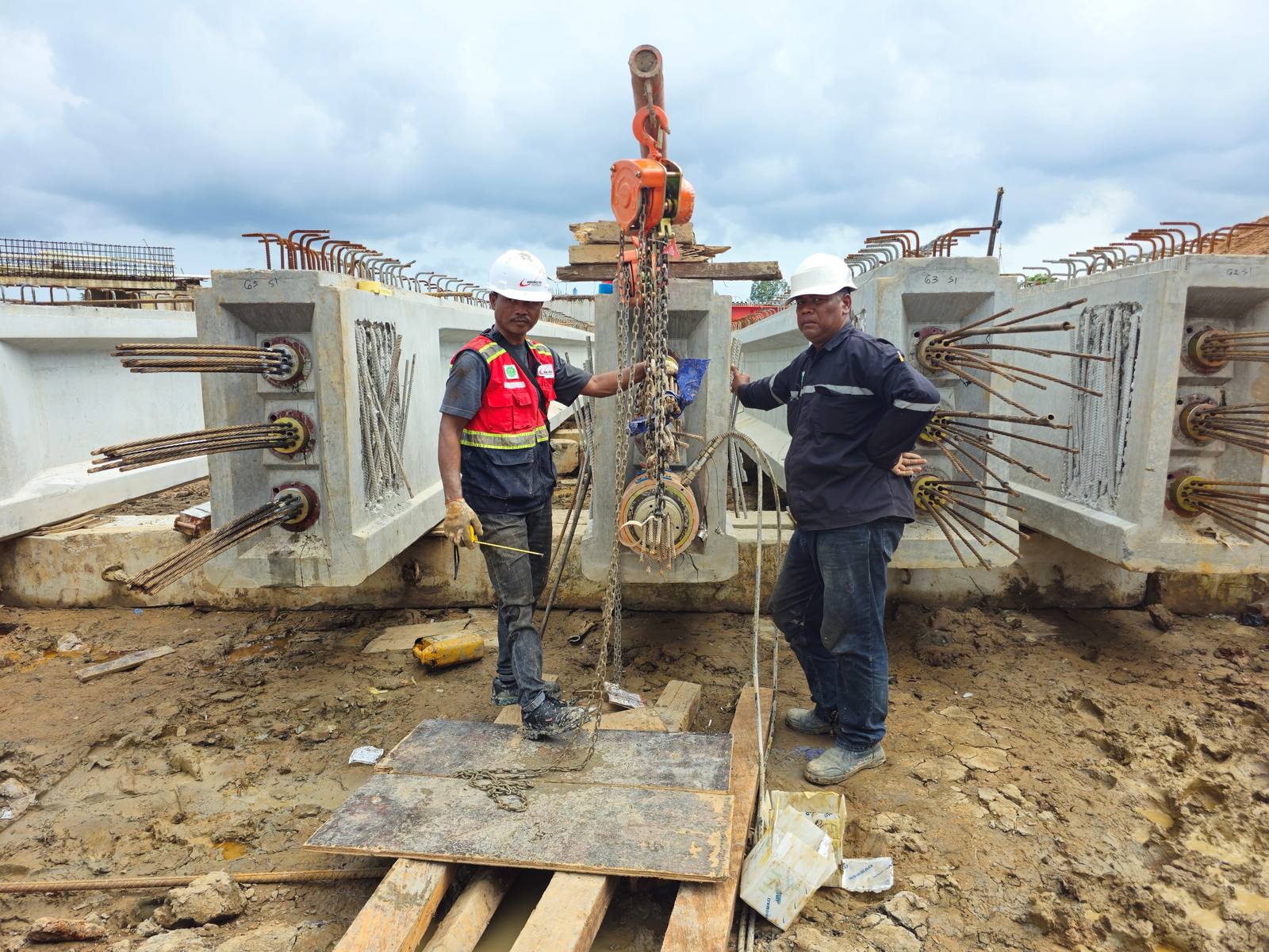 Engineers supervising girder stressing works